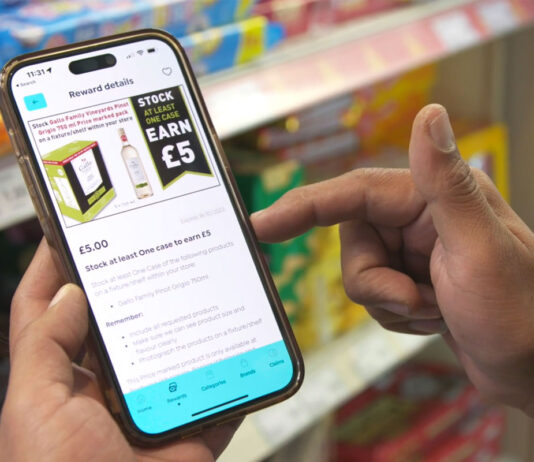 A one size fits all solution in retail comes from *shopt A person is using the *shopt retailer app on their phone in store.
