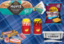 Product shots sit on top of a blue tartan background including Tunnock's biscuit range, Hovis Bakers Since 1886 Rustic White Bloomer loaf, Coca-Cola Original Taste Lemon and Zero Sugar Lemon, McCain Air Fryer French Fries and Lurpak Spreadable.