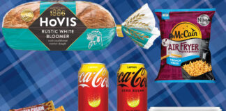 Product shots sit on top of a blue tartan background including Tunnock's biscuit range, Hovis Bakers Since 1886 Rustic White Bloomer loaf, Coca-Cola Original Taste Lemon and Zero Sugar Lemon, McCain Air Fryer French Fries and Lurpak Spreadable.