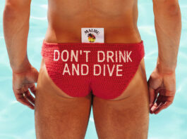 Tom Daley dives into responsible drinking campaign with Malibu Olympic diver Tom Daley stands in front of a pool in diving clothing with a Malibu branded tag sticking out the clothes with the text reading 'Don't Drink and Dive'.