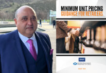 Pete Cheema, chief executive of the SGF stands outside Scottish Parliament with an image of the SGF Guide to MUP 2024 next to him.