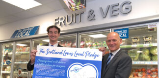 Jamie Buchanan, SGF’s Go Local programme director, right, and colleague Aidan Smith signing the Scotland Loves Local Pledge.