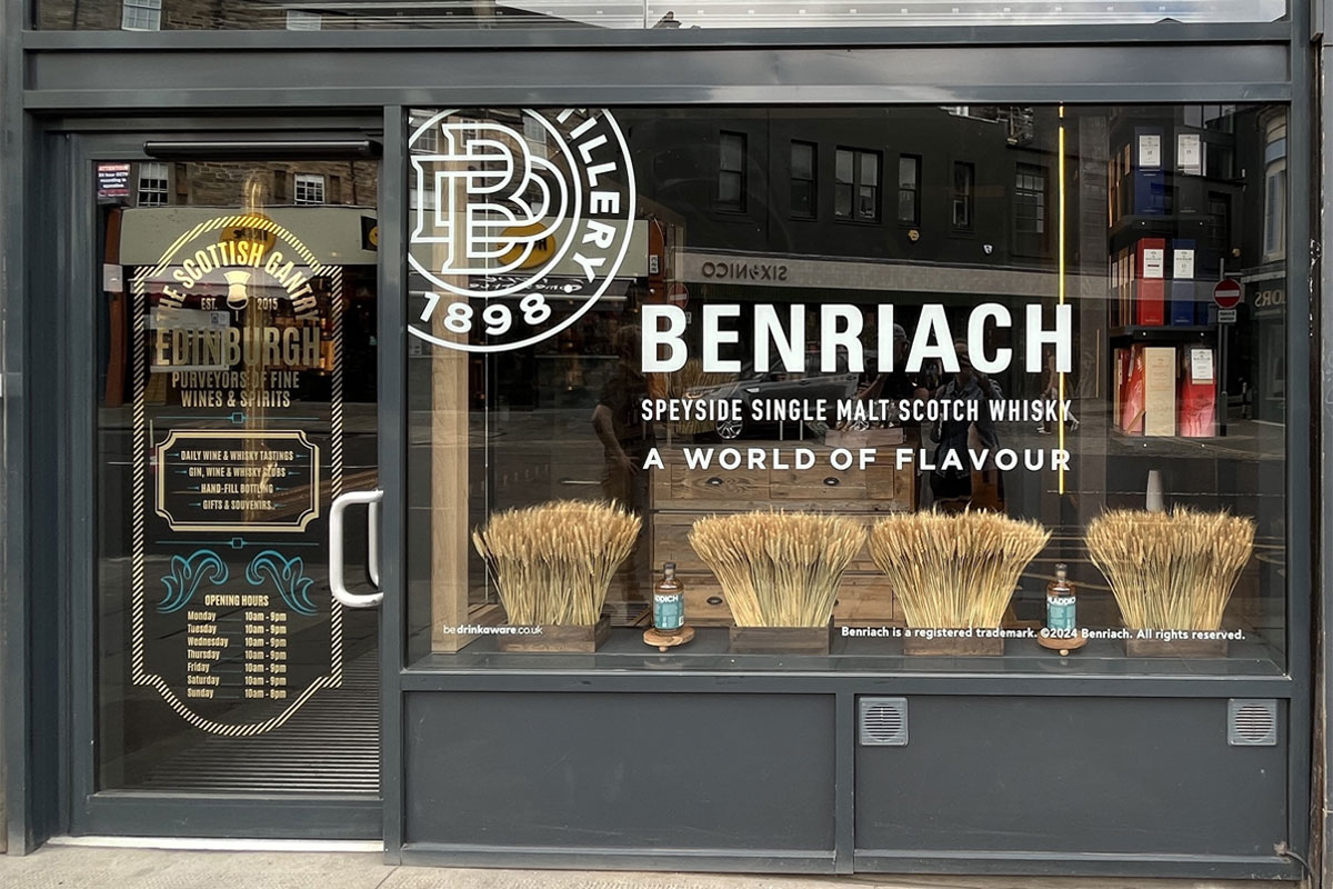 Store front of The Scottish Gantry store in Edinburgh with advertising for The Benriach single malt in the window.