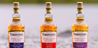 Bottles of Tomintoul whisky stand in water.