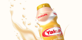 Promotional image of Yakult Plus Peach with a bottle of the drink surrounded by the liquid.