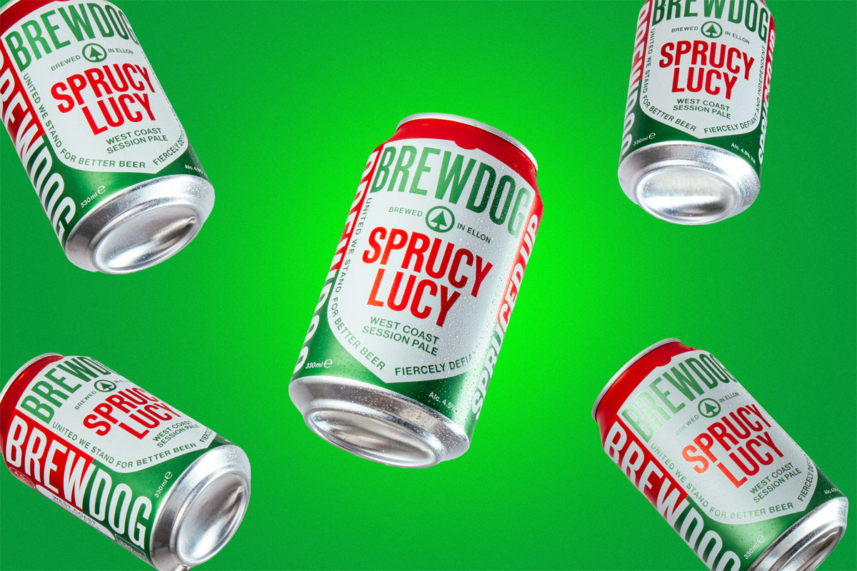 Cans of BrewDog Sprucy Lucy pale ale fall against a green background.