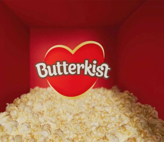 Butterkist pops on the small screen TV ad for Butterkist featuring a pile of popcorn in a red room with the Butterkist logo in the centre.