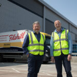 JW Filshill records strong financial results Simon Hannah, group chief executive officer at JW Filshill,(left) and Keith Geddes, chief financial and operating officer, (right) stand in front of the JW Filshill depot with one of the wholesaler's HGV vehicles behind them.