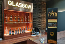 The Glasgow Distillery meeting room with a pack of Glasgow 1770 Tokaiji Cask Finish in front with a nosing glass next to it.