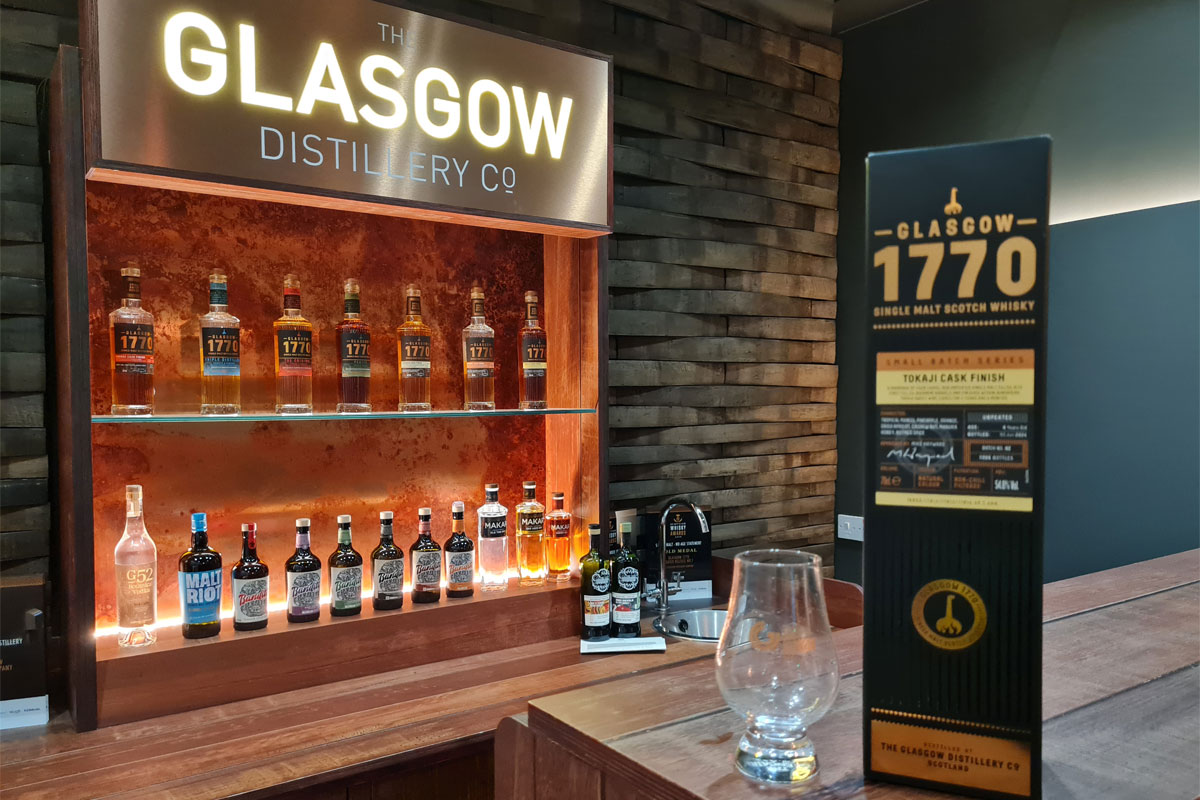 The Glasgow Distillery meeting room with a pack of Glasgow 1770 Tokaiji Cask Finish in front with a nosing glass next to it.