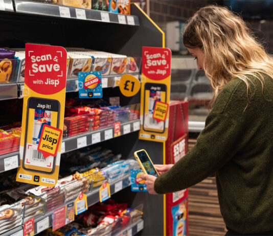 Jisp marks three years of Scan & Save A woman uses her phone to redeem rewards of Jisp's Scan & Save app with promotions highlighting the app on store shelves.