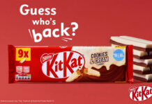 Promo of the return of KitKat Cookies & Cream two finger biscuits, with a pack shot of the multipack and unwrapped KitKat Cookies & Cream biscuits to the side against a red background. The text reads "Guess who's back?".