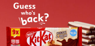 Promo of the return of KitKat Cookies & Cream two finger biscuits, with a pack shot of the multipack and unwrapped KitKat Cookies & Cream biscuits to the side against a red background. The text reads "Guess who's back?".