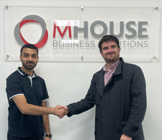 MHouse ties up with Volumatic to streamline the process Faisal Sattar, chief exec at MHouse, and Tom Walker, Volumatic's Scotland Account manager. shake hands in front of the MHouse logo.