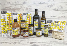 A range of foods of Realfoods by Organico sit on a countertop with a grey background.