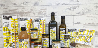 A range of foods of Realfoods by Organico sit on a countertop with a grey background.