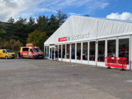 CJ Lang strengthens supplier relationships Image of the front of the Spar Scotland trade show tent with vans parked outside.