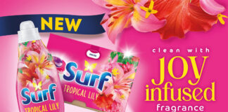 Promotional image of the Surf laundry detergent rebrand, with pack shots of the products against a pink background that has flowers. The text reads 'clean with joy infused fragrance'.