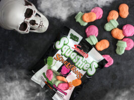 Swizzels brings the Squeals this Halloween A packet of Swizzels Squashies Squeletons lie on a table with the sweets spilled out, above the packet is a skull and fog at the top and bottom of the image.