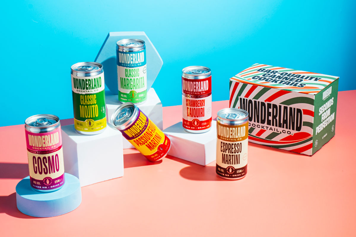 Lifestyle image of the Wonderland Cocktails range including a multipack as well as single cans of cocktails.