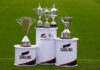 Scottish Premier Football League trophies on stands on a football pitch with Carling branding on the stands.