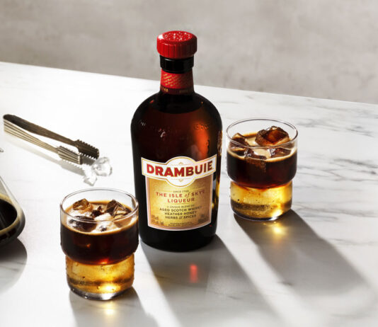 Drambuie brings an ‘OOOO’ with its new campaign A bottle of Drambuie with two Drambuie Iced Espresso serves stand next to the bottle on a countertop.