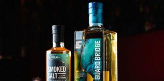 A bottle of Eden Mill's The Guard Bridge blended whisk stands next to a bottle of Smoked Salt Sugar Syrup.