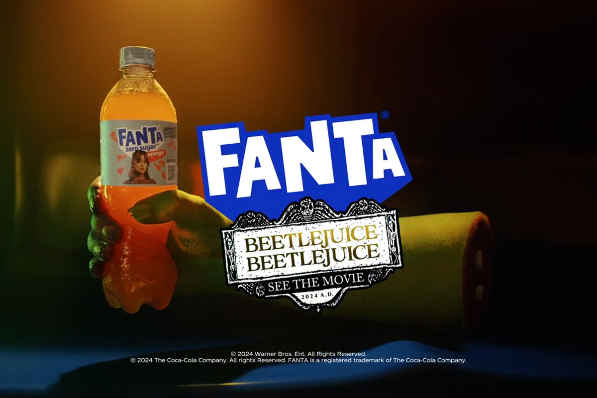 Advert for Fanta Beetlejuice Beetlejuice advert with a ghoulish hand holding a bottle of Fanta Zero with the Fanta logo and Beetlejuice Beetlejuice logo in front of the hand.