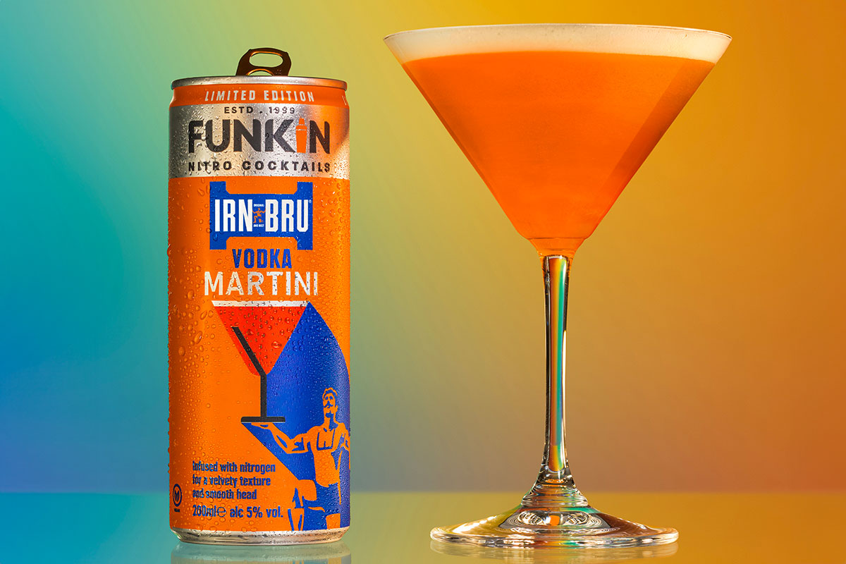 Life style image of a Funkin Cocktails Irn-Bru Vodka Martini can with the drink served in a martini glass next to it.