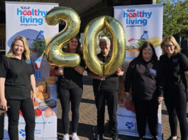Healthy Living Programme marks 20 years The SGF Healthy Living Programme team stand holding a two balloon and a zero balloon together in front of HLP branded stands.