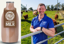 Bryce Cunningham, founder of Mossgiel Farm, stands in a field with cows behind him with a pack shot of a Mossgiel Dairy Farm Chocolate Milk bottle.