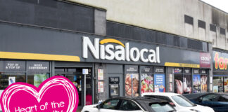 Image of a Nisa Local storefront in Cambuslang with cars parked out front and the Nisa Making a Difference Locally charity Heart of the Community logo to the side.