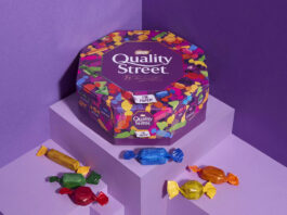 Nestlé trials paper Quality Street tubs Promotional image of Quality Street paper tubs featuring the tub and sweets from the tub against a purple background.