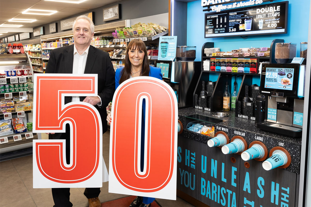 Stephen Brown, head of food to go at CJ Lang & Son, and Keavy O'Mahony-Truesdale, brand manager at Barista Bar, both hold a large 50 to mark the 50th installation of the coffee service in Spar Newhouse Road in Falkirk.