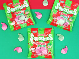 Packets of Swizzels Squashies Naughty & Nice sit against a red and green backdrop with the sweets scattered across the table.