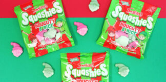 Packets of Swizzels Squashies Naughty & Nice sit against a red and green backdrop with the sweets scattered across the table.