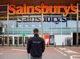 We hae meat expands into Sainsbury’s A person in a 'We hae meat' branded jumper stands in front of the entrance to a Sainsbury's supermarket.
