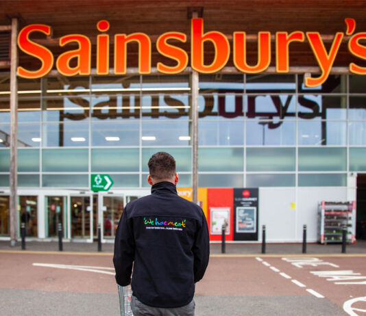 We hae meat expands into Sainsbury’s A person in a 'We hae meat' branded jumper stands in front of the entrance to a Sainsbury's supermarket.