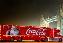 The Coca-Cola Christmas Truck for 2024 season is in front of Tower Bridge during the night.