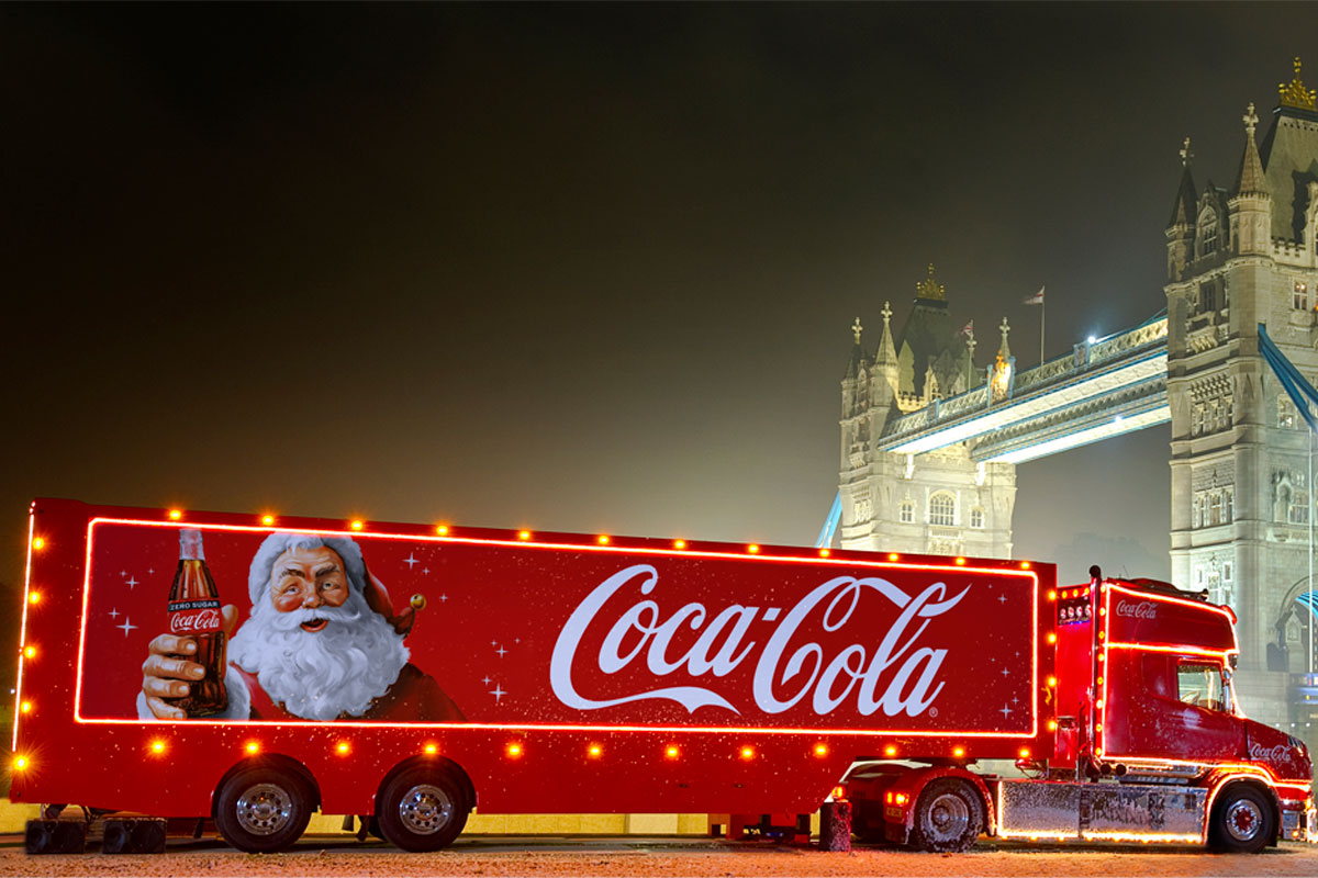 The Coca-Cola Christmas Truck for 2024 season is in front of Tower Bridge during the night.