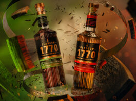 Glasgow Distillery rolls out for Christmas Bottles of Glasgow 1770 Cask Strength crash through a whisky cask with red and green lighting.