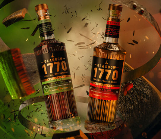 Glasgow Distillery rolls out for Christmas Bottles of Glasgow 1770 Cask Strength crash through a whisky cask with red and green lighting.