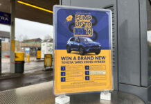 A Jet forecourt garage with a POS highlighting a prize giveaway to win a new car.