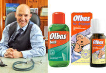 Dr Roger Henderson, GP and spokesperson for Olbas, sits at a table with pack shots of Olbas Bath and Olbas For Children Inhalant Decongestant Oil.