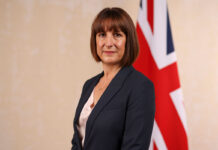 Chancellor of the exchequer Rachel Reeves stands in front of a Union Jack flag.