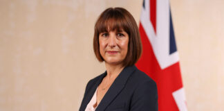 Chancellor of the exchequer Rachel Reeves stands in front of a Union Jack flag.