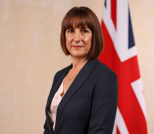 SGF warns budget will cost c-stores millions Chancellor of the exchequer Rachel Reeves stands in front of a Union Jack flag.