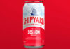 A can of Shipyard American Pale Ale is against a red background.