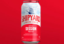 A can of Shipyard American Pale Ale is against a red background.