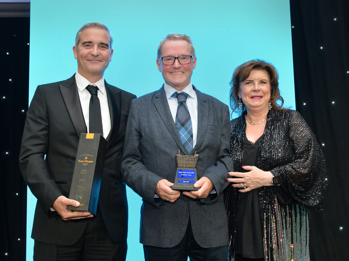 Billy Gatt receives the Entrepreneur Award from JTI area sales manager Stephen Donaghy and actress Elaine C Smtih, who presented the Scottish Grocer Awards.